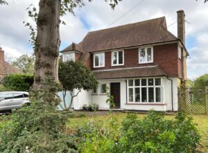 A traditional two-story home featuring heritage windows and replacement aluminium windows that preserve its period charm.
