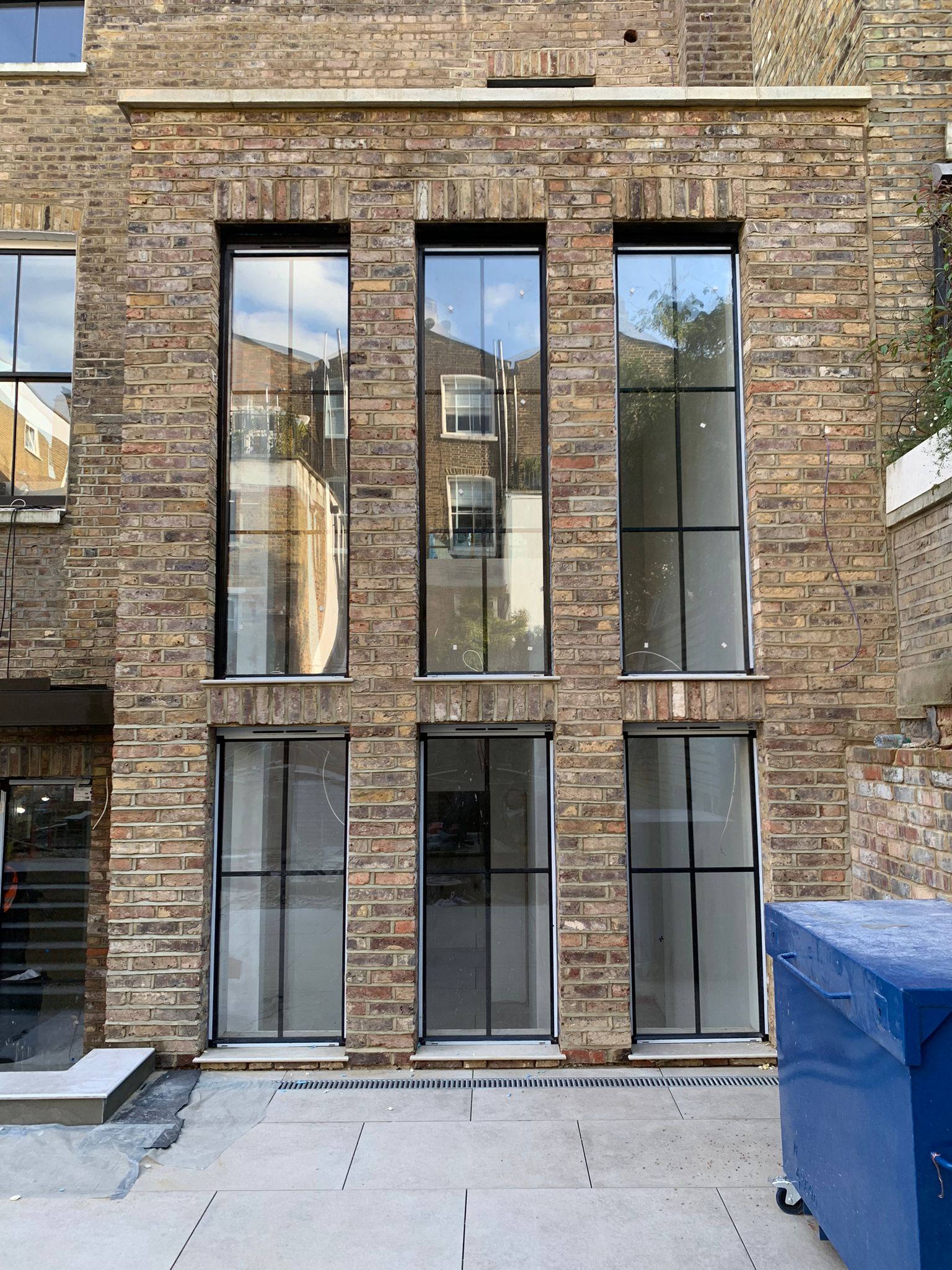 Contemporary brick building showcasing tall feature windows, emphasising vertical elegance and natural light.