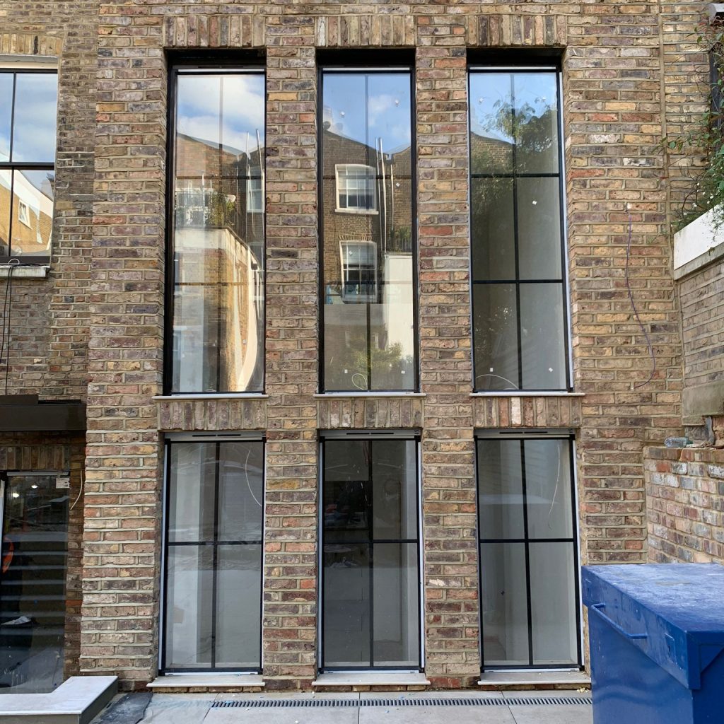 Contemporary brick building showcasing tall feature windows, emphasising vertical elegance and natural light.
