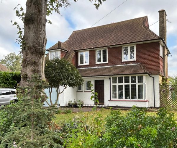 A traditional two-story home featuring heritage windows and replacement aluminium windows that preserve its period charm.
